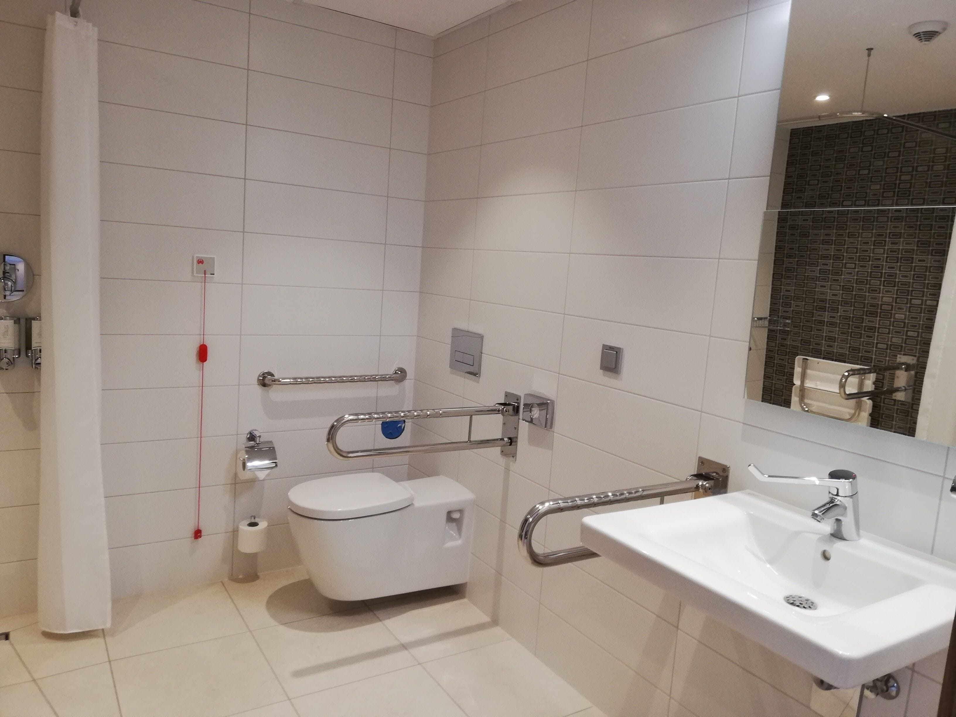 A modern bathroom with a toilet, bidet, and sink.
