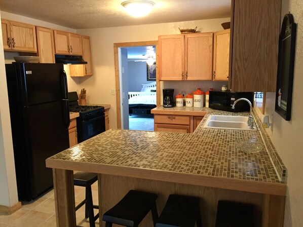 Microwave, coffee/tea maker, toaster, cookware/dishes/utensils