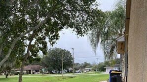 A residential area with a paved pathway, outdoor lighting, and a Christmas sign. - Lake Front Sebring Villa , Relax- Quiet with Breathtaking views! (Sebring)