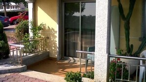 A small outdoor patio area with a table and chairs, surrounded by plants and a cactus. - Apartamentos Mirador de Ons for 2 people (Sanxenxo)