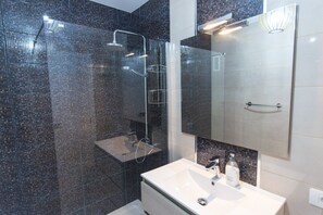 Shower, hair dryer, towels, toilet paper