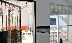 Relax on the balcony with a casual dining or relaxation area, featuring a table and chair.