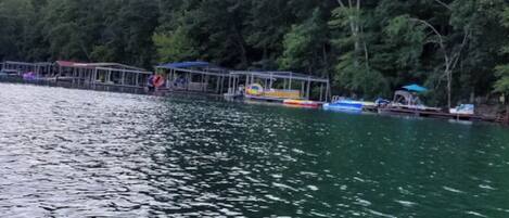 A calm lake with a dock and boats.