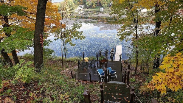 A lakeside deck with outdoor seating and a view of the lake. - One Minute to Road America - Close to PGA Golfing (Plymouth)
