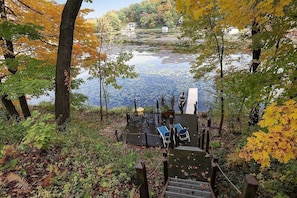 A lakeside deck with outdoor seating and a view of the lake.
