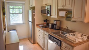 A kitchen with white cabinets, a stainless steel refrigerator, a microwave, a toaster, and a dishwasher. - Completely updated 1 bedroom condo unit-steps to a shared private beach! (Dennis Port)