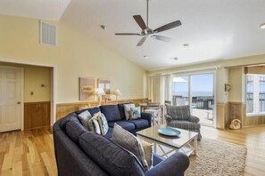 A living room with a sofa, armchair, and coffee table.