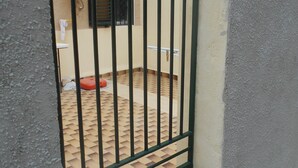 A gated entrance with a tiled patio area visible through the bars. - "L'Antica Locanda" House (Catona)