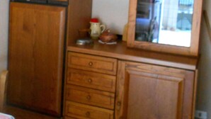 A kitchen with wooden cabinets, a refrigerator, a sink, and a mirror above the countertop. - "L'Antica Locanda" House (Catona)