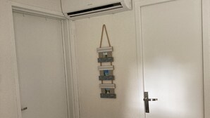 A room with a white door, a white ceiling, and a white air conditioning unit mounted on the wall. - typical small house, air-conditioned fisherman's farmhouse (swimming pool, jacuzzi, sauna, fitness room) (Le Barcarès)