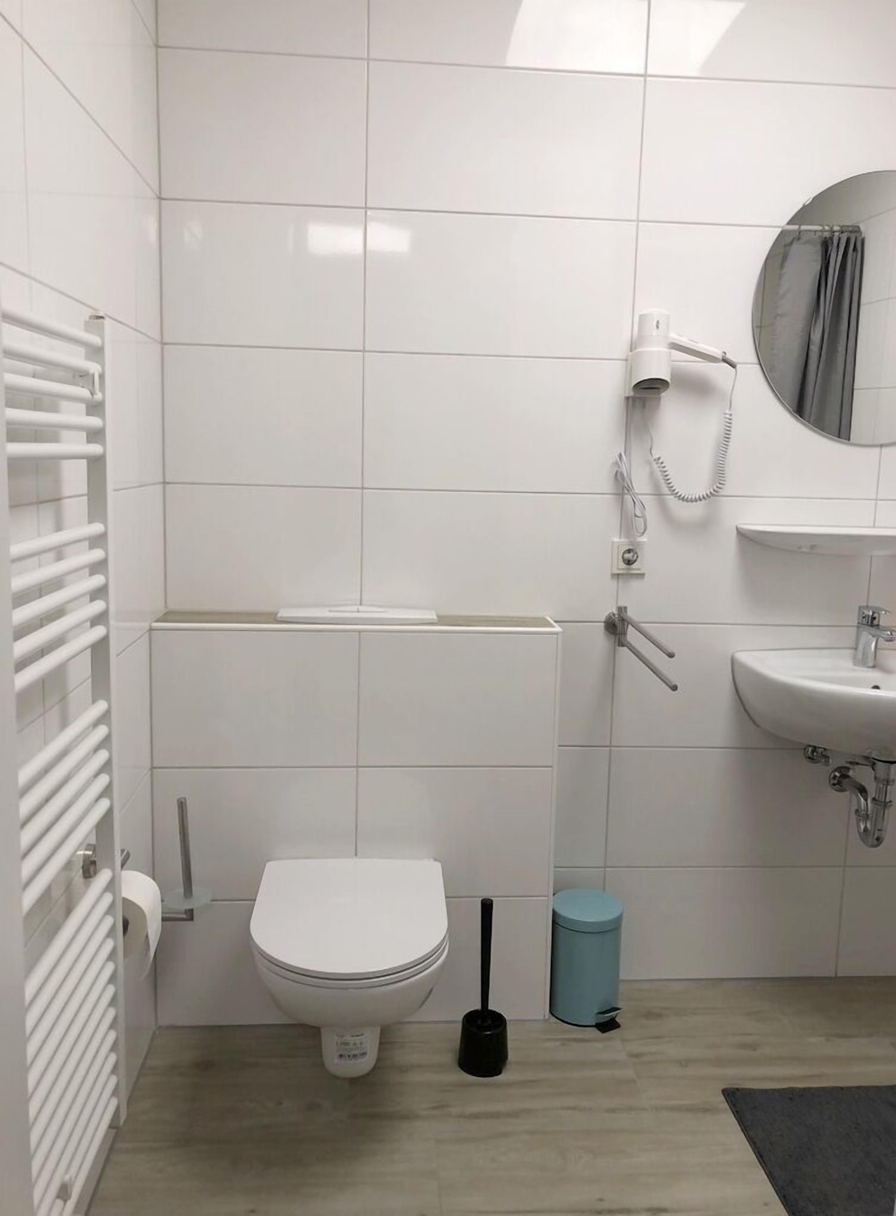 A modern bathroom with a toilet, bidet, and sink.