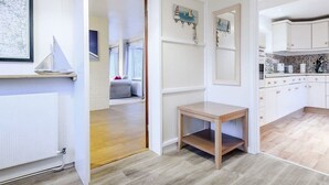 Una cucina moderna con mobili bianchi e pavimento in legno.