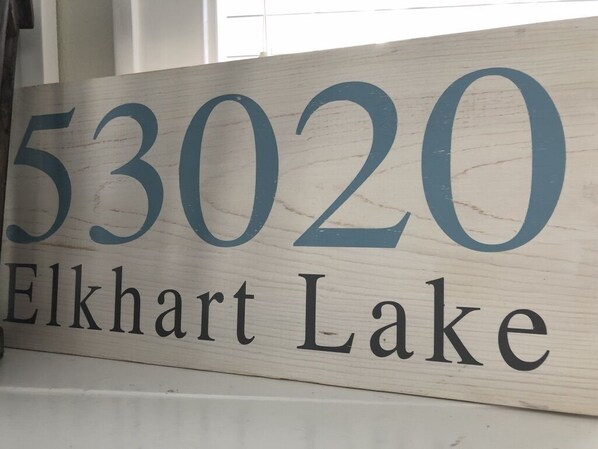 A wooden sign with the number 53020 and the text 'Elkhart Lake'.