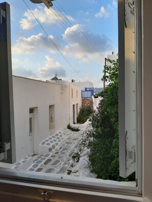 Stroll down this charming cobblestone street to a historic building with a blue gate.