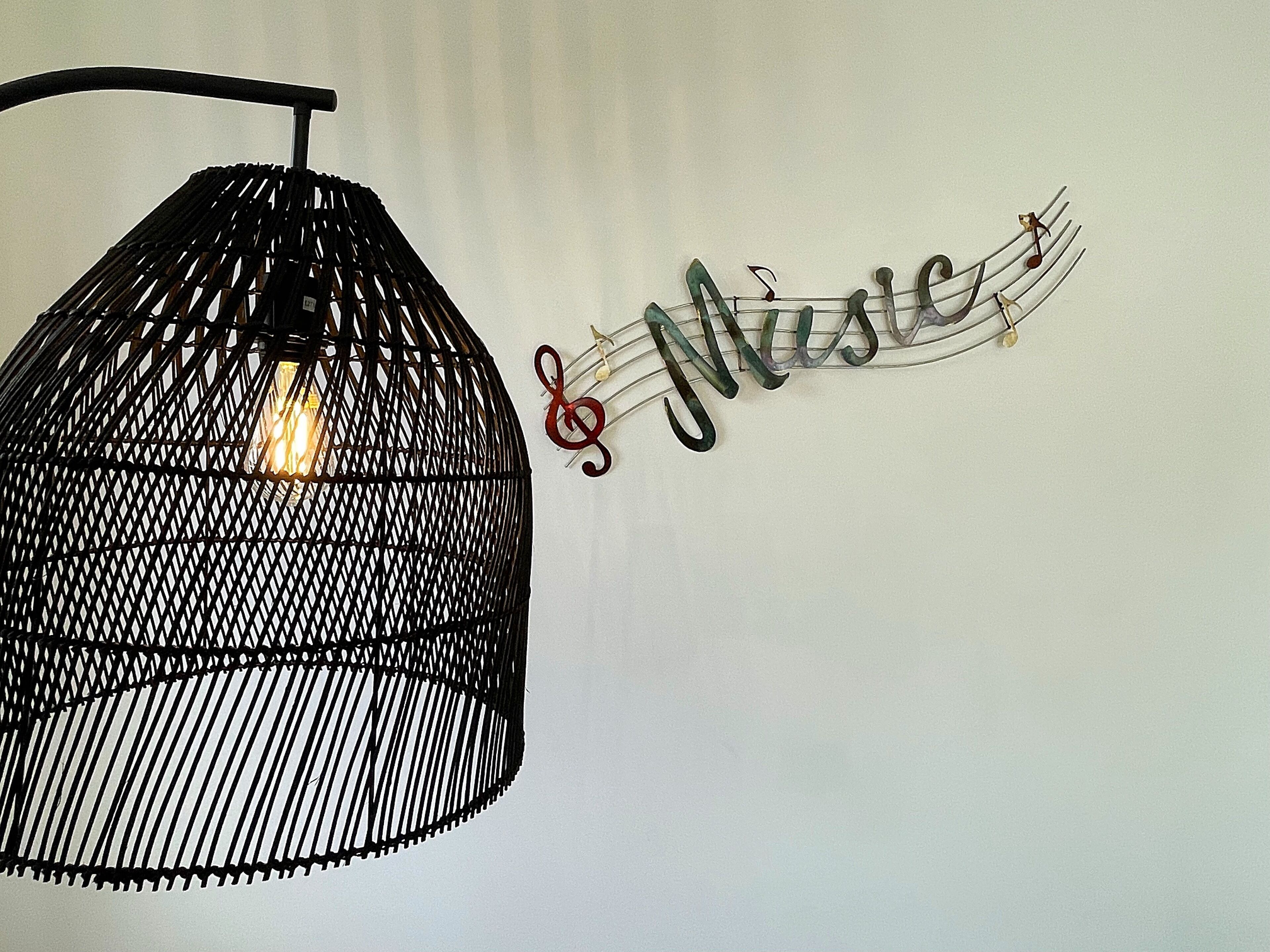 A black hanging light fixture with a visible bulb inside.