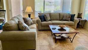 A living room with two sofas, a coffee table, and a lamp. - STEPS From the Pool! Relax in your Comfy Pool-side Condo! (Oro Valley)