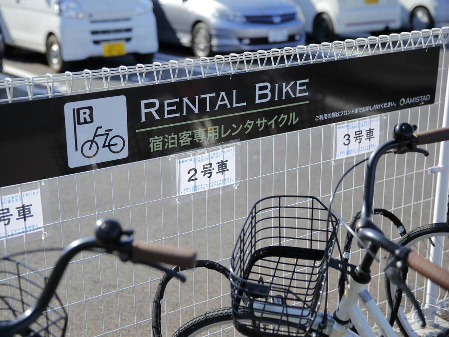 A rental bike station with a sign indicating bike availability.