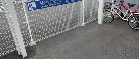 A motorcycle parking lot with a sign indicating it is for hotel guests.