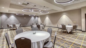 A conference room with round tables, grey chairs, and modern circular ceiling lights. - Holiday Inn Appleton by IHG (Appleton)