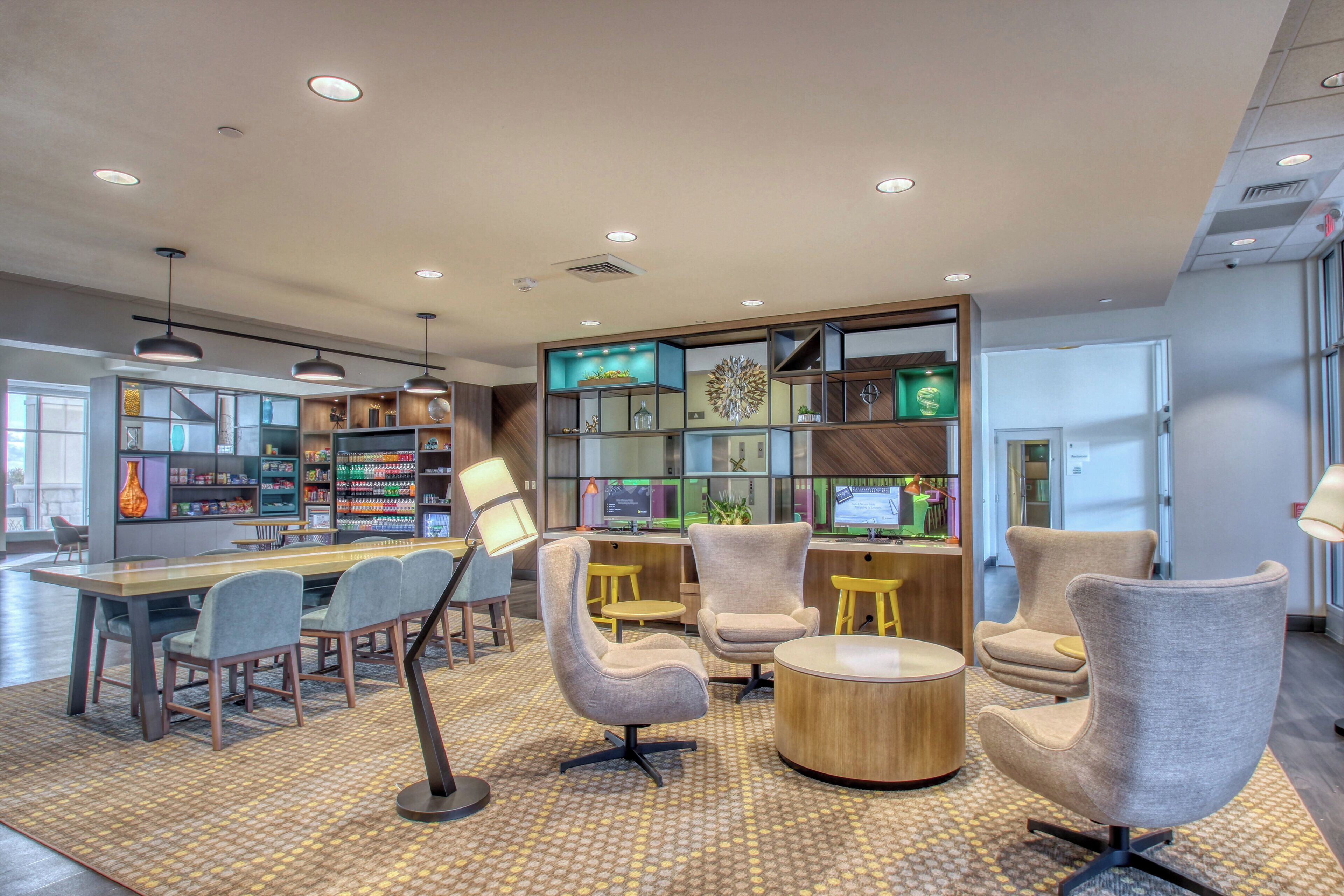 A modern interior with seating, a counter, and a variety of decorative items.