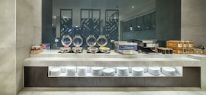 A breakfast buffet setup with various food items and condiments. - Holiday Inn Express Melbourne Southbank by IHG (Southbank)