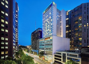 A modern hotel with multiple floors, large windows, and a prominent sign. - Holiday Inn Express Melbourne Southbank by IHG (Southbank)