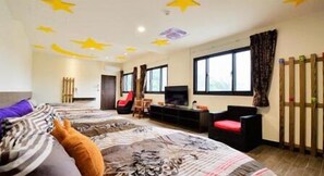 A hotel room with a large bed, a TV, a sofa, and a window with curtains. - Xitou Royal Villa (Lugu)