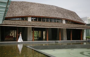 A modern building with a curved roof and large windows. - Veranda Pool Villa (Cha-am)
