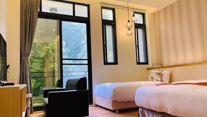 A bedroom with a bed, a desk, a chair, and large windows with curtains. - Yuan Ju Boutique Hotel (Yuchi)