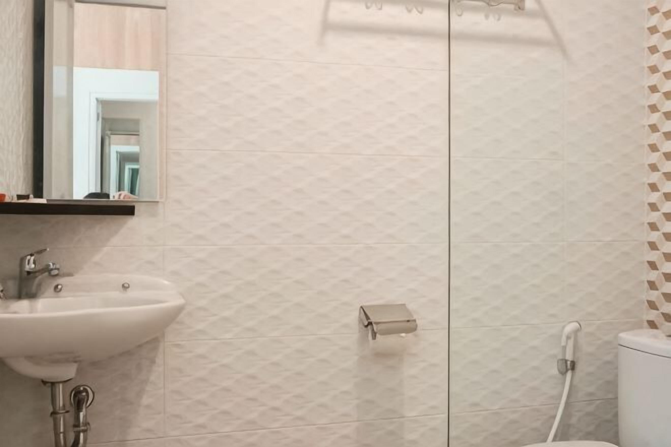A bathroom with a sink, mirror, and toilet.