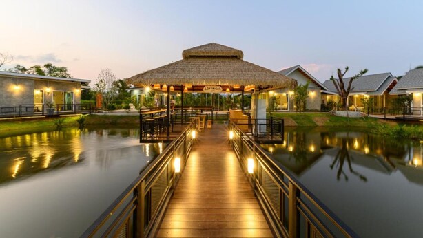 A wooden bridge leading to a thatched-roof structure with a sign reading "LOFTICAL." - Loftpical Resort (Ko Kaeo)