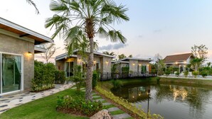 A modern resort with multiple villas, a central water feature, and well-maintained gardens. - Loftpical Resort (Ko Kaeo)