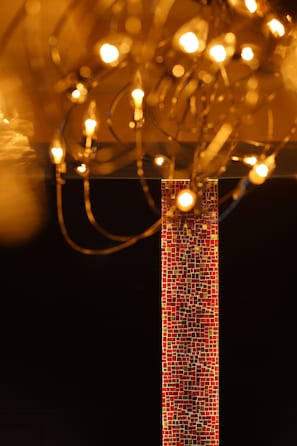 A vertical mosaic wall with a series of hanging lights. - Fontaine Bleau Sengokutei (Hakone)