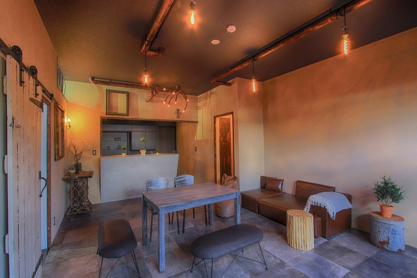 A cozy interior with a dining area, seating, and a kitchen.