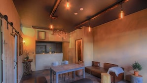 A cozy interior with a dining area, seating, and a kitchen. - Fujinokura Tiny Fort (Fujiyoshida)