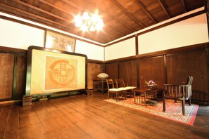 A traditional Japanese room with wooden flooring, tatami mats, and a low table with chairs. - Kongo Sanmaiin (Koya)
