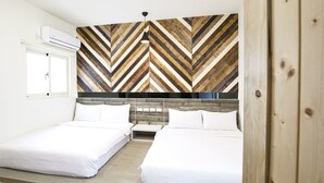 A hotel room with two beds, a wooden herringbone-patterned wall, a ceiling fan, and a window with an air conditioning unit. - Amethyst Bay 2 (Magong)