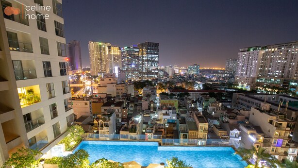 A nighttime cityscape with a swimming pool surrounded by buildings. - Celine Home Millenium (Ho Chi Minh City)