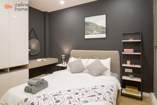 A modern bedroom with a bed, pillows, a bedside table, a wall-mounted shelf, and a framed picture. - Celine Home Millenium (Ho Chi Minh City)