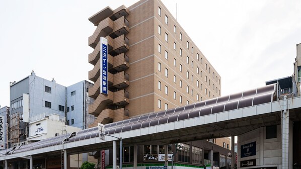 A multi-story building with a prominent blue sign on the side. - Sanco INN Numazu-ekimae (Numazu)