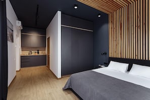 A modern bedroom with a bed, bedside table, and a wooden slat wall. - GoodZone Club Panorama Zatoka (Zatoka)