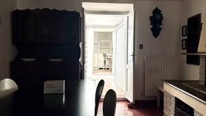 A dining area with a table, chairs, a cabinet, and a sign. - N158 - Numana, sky-land sea view 150mt from the sea (Numana)