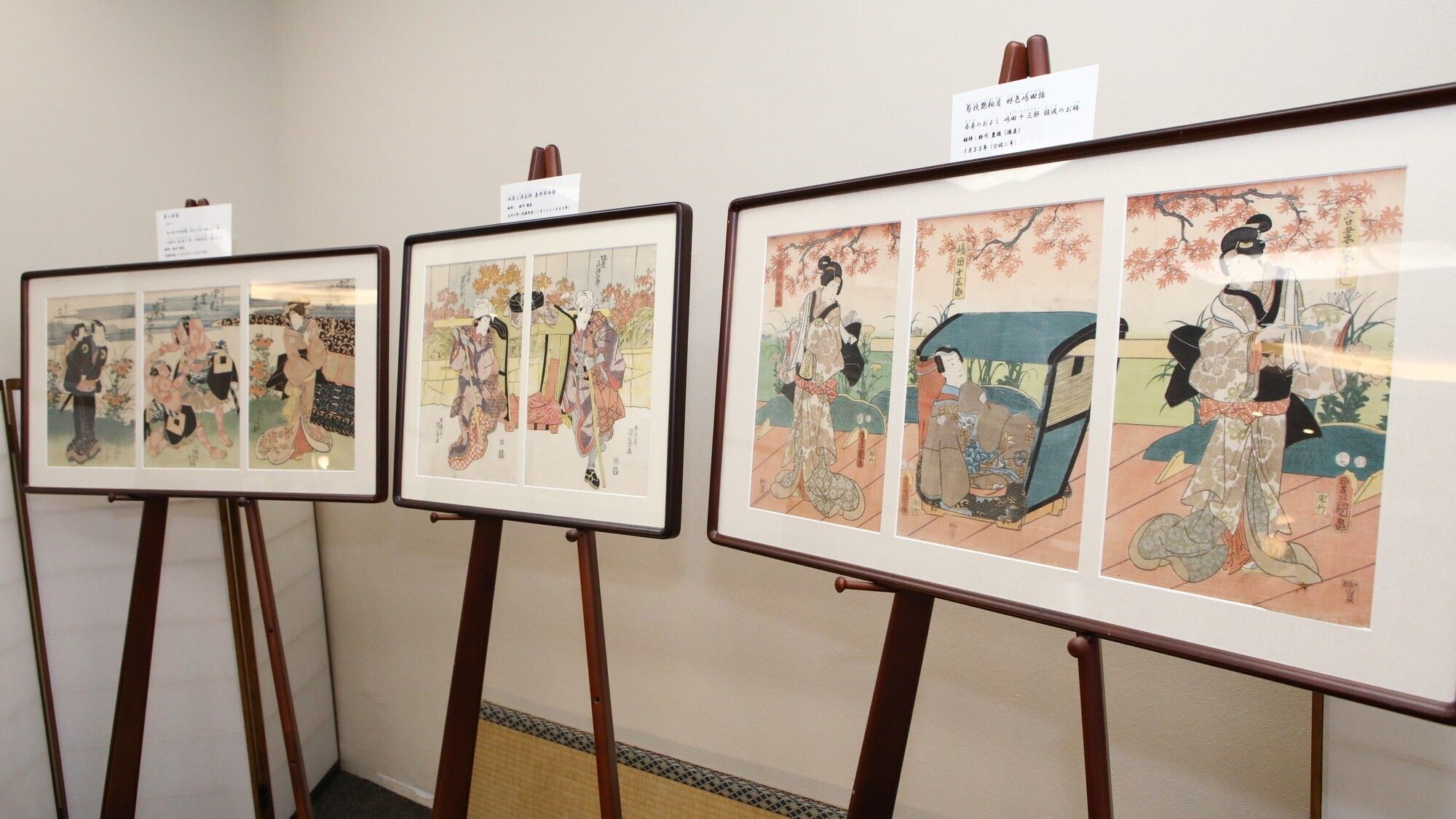 A series of framed artworks on easels in an indoor setting.