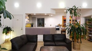 A modern living room with a sofa set, a coffee machine, and a large potted plant. - Family Lodge Hatagoya Nikko Kinugawa (Nikko)