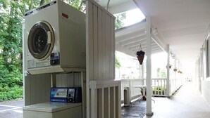 A covered porch with a washing machine and dryer, a hanging planter, and a view of the street. - Family Lodge Hatagoya Nikko Kinugawa (Nikko)