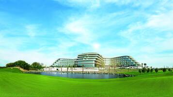 Situated on a well-maintained lawn, this hotel features a unique curved facade and multiple levels.