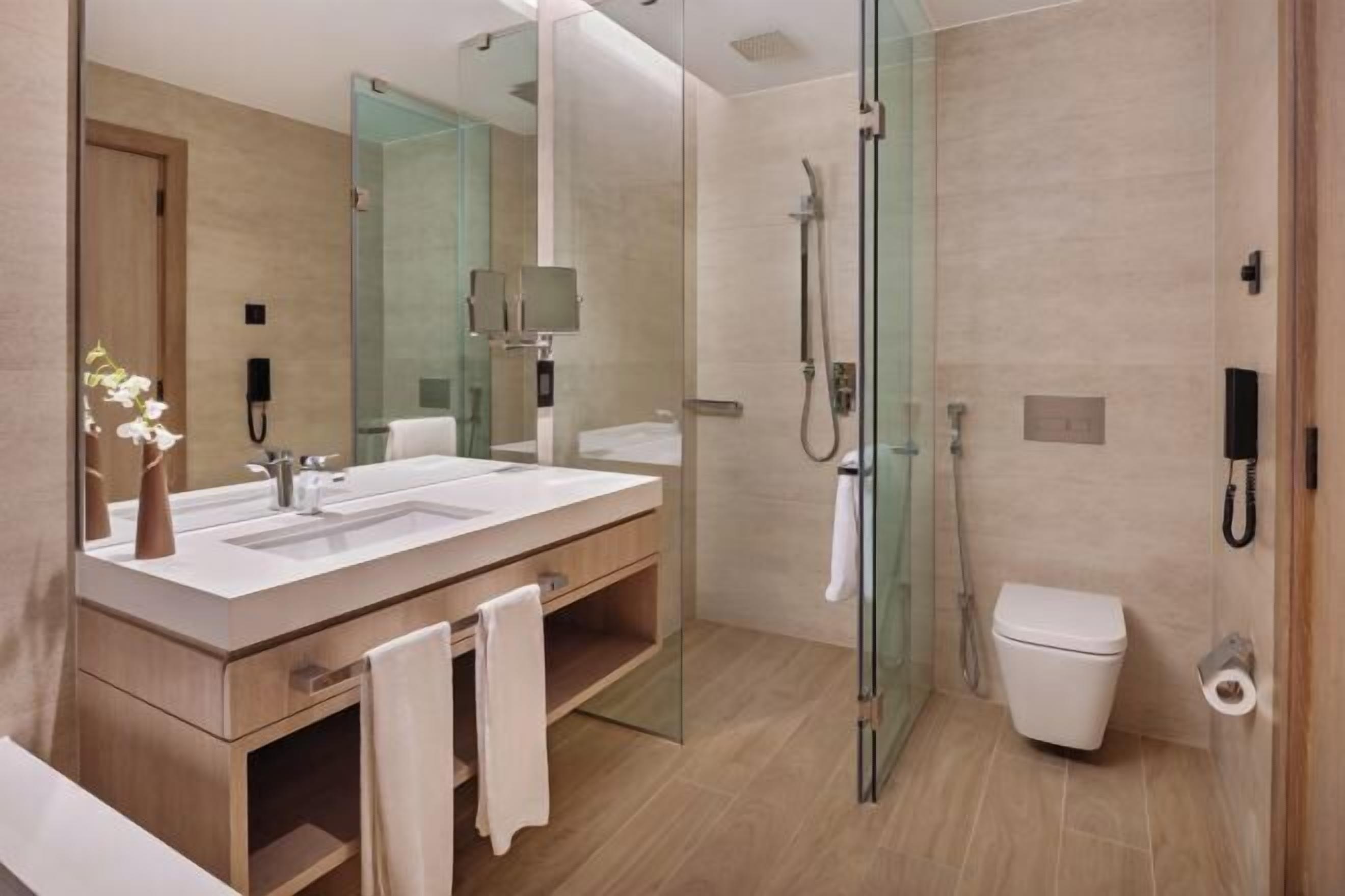 Deep soaking tub, rainfall showerhead, designer toiletries, hair dryer