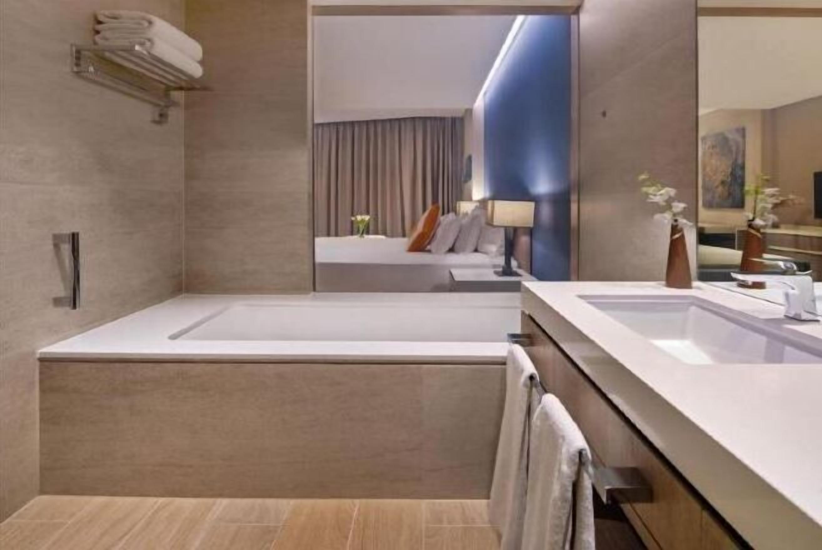 Salle de bain | Baignoire profonde, douche cascade, articles de toilette griffés