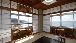 A traditional Japanese room with tatami flooring, shoji screens, and a view of the sea. - Furusato No Yado Kobase (Echizen)