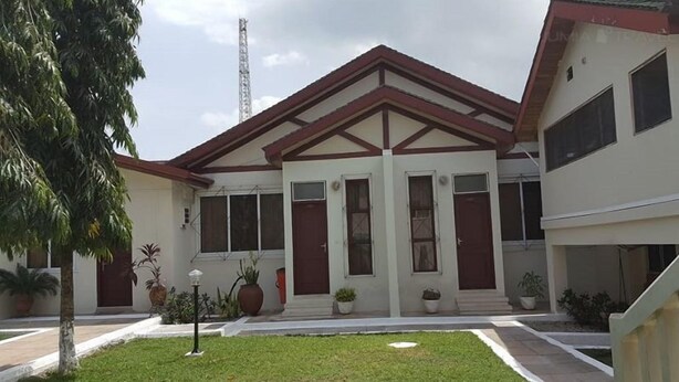 A two-story building with a symmetrical facade, large windows, and a central entrance. - Trust Lodge (Sekondi-Takoradi)